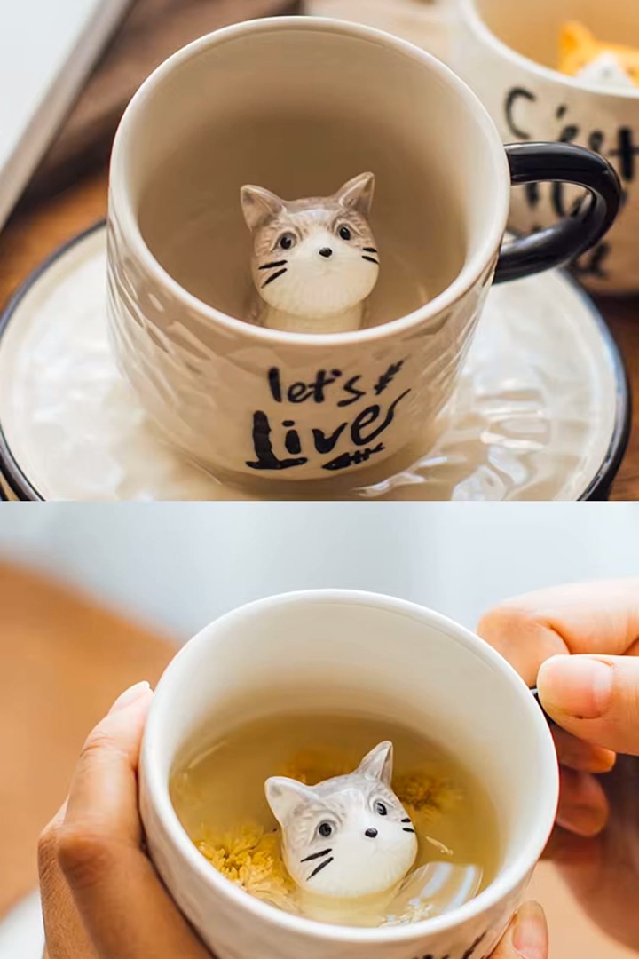 Tasse mit Untertasse mit Keramikkatze in der Mitte